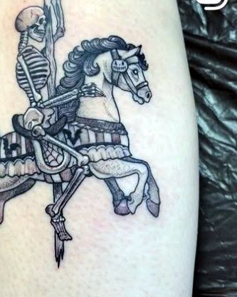 Skeleton riding a carousel horse