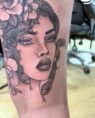 Gothic woman wrapped in a snake and roses